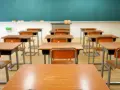 Puste ławki i krzesła w sali lekcyjnej. Ktoś zapomniał o usprawiedliwieniu nieobecności w szkole.