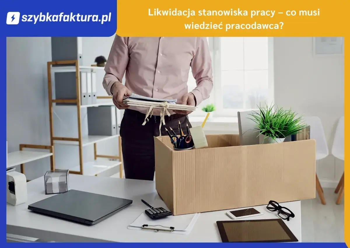 Pracownik pakuje rzeczy do kartonu, co symbolizuje likwidację stanowiska pracy. Na biurku laptop, kalkulator i dokumenty.